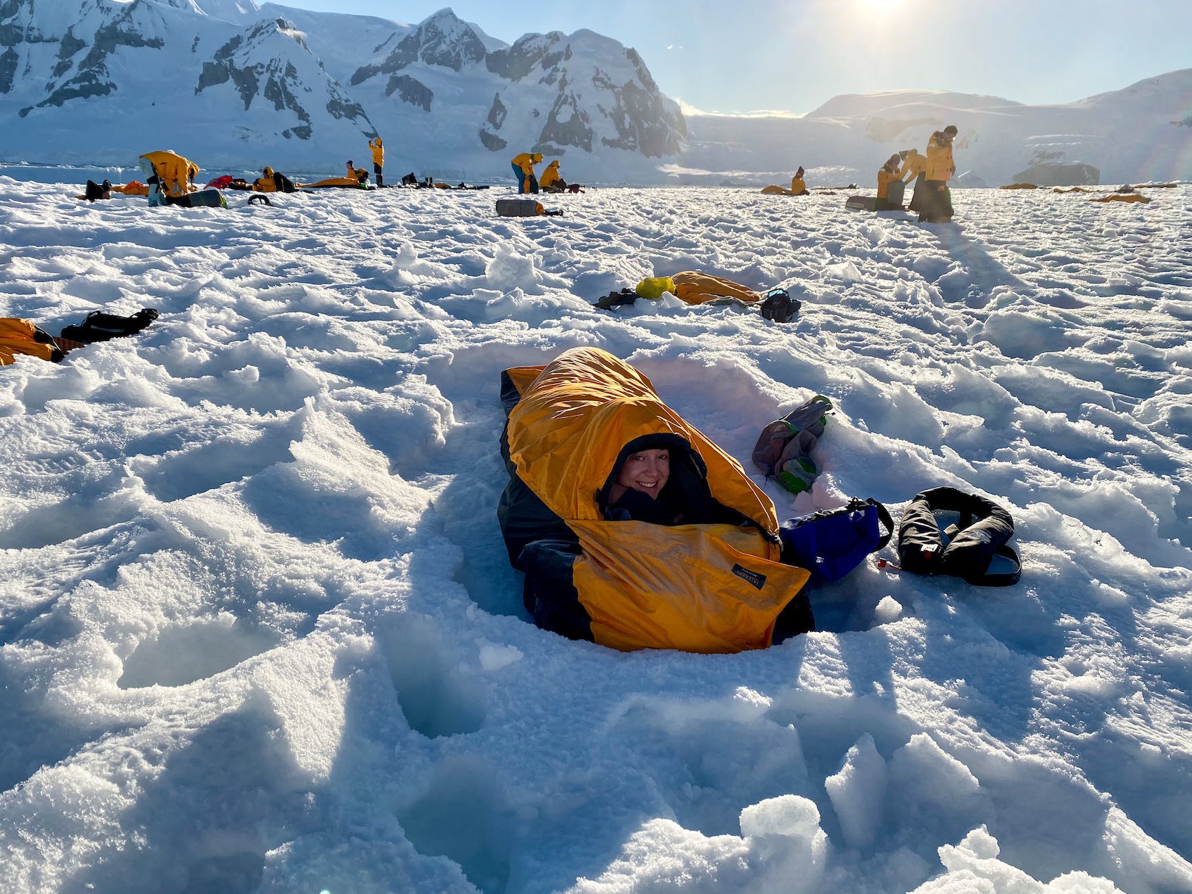 woman lying in a sleeping bag in snow